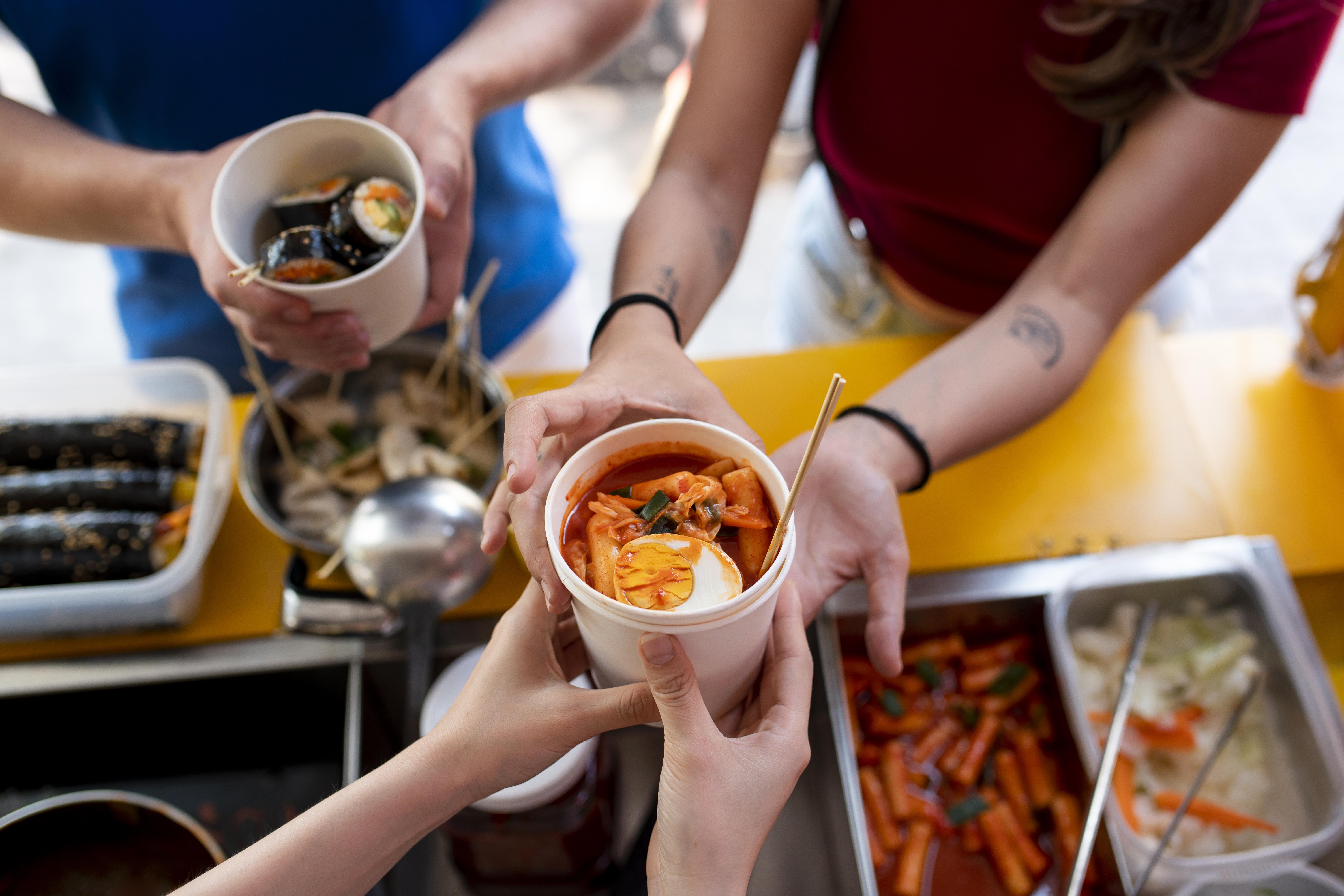 close-up-hands-holding-cup-with-food